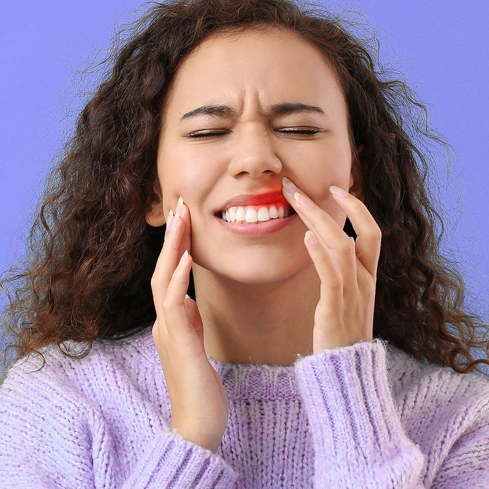 Girl with gum pain